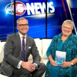 Joanie appearing on local news featuring book release