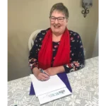 Joanie signing book contract