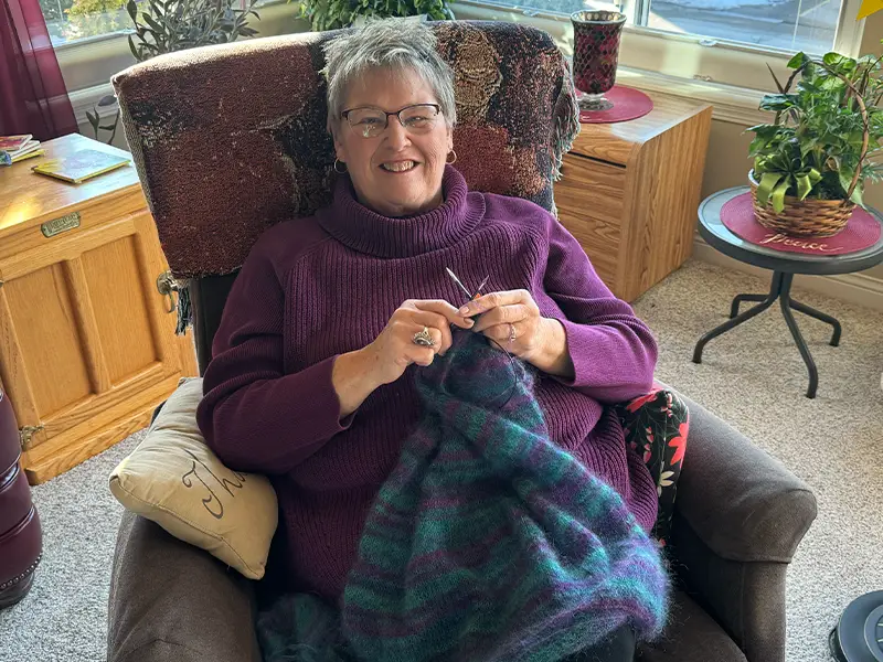 Joanie knitting in chair