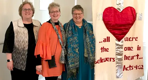 Joanie after speaking at one heart women's conference with other women attendees